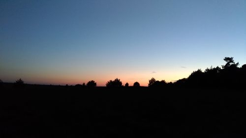 Silhouette landscape against clear sky