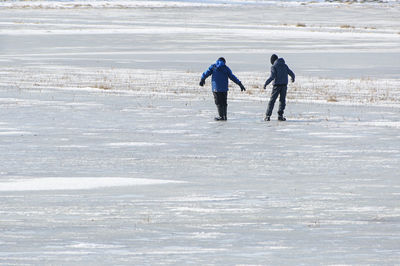 Full length of people walking on beach