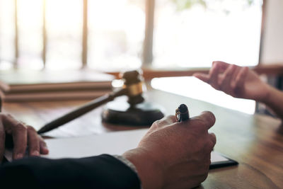 Close-up of judge writing on table