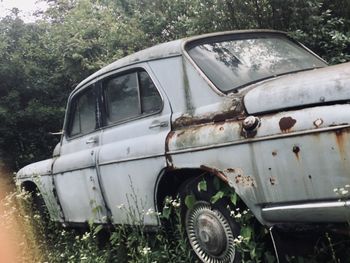 Abandoned car on field