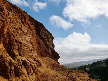 Low angle view of rock formations against sky