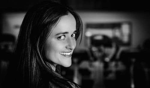 Portrait of young woman looking over shoulder