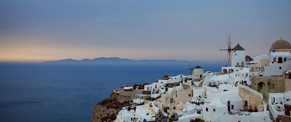 High angle view of oia village by sea at santorini against sky