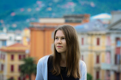 Portrait of young woman in city