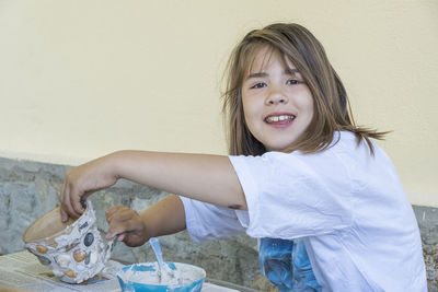 Portrait of smiling young woman sitting at home