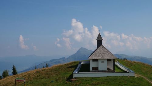 Traditional building on mountain against sky