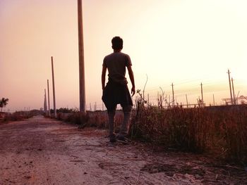 Rear view of man standing on field