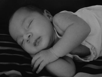 Close-up of baby sleeping on bed