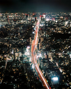 High angle view of illuminated city buildings at night