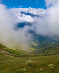 Landscape of the caucasus mountains, clouds descend from the peaks.