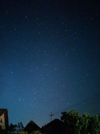 Low angle view of silhouette trees against sky at night