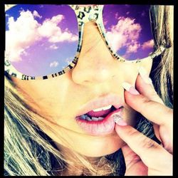 Close-up of hand against cloudy sky