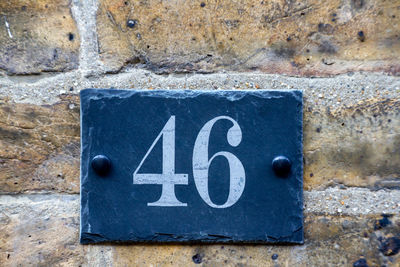 House number 46 on a brick wall in london