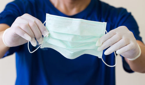 Close-up of woman holding blue umbrella