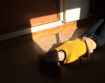 Young woman lying on floor at home