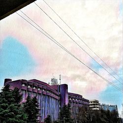 Low angle view of pink building against sky