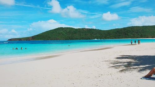 Scenic view of beach against cloudy sky