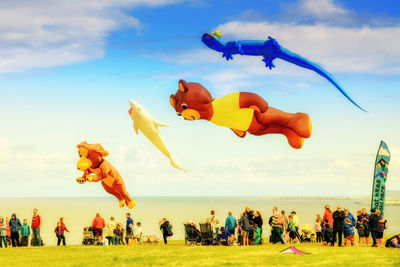 People flying against blue sky