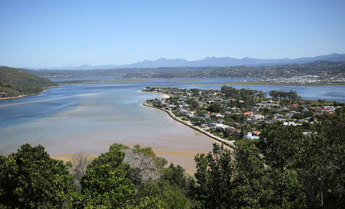 High angle view of sea and trees against sky