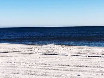 Scenic view of sea against clear blue sky