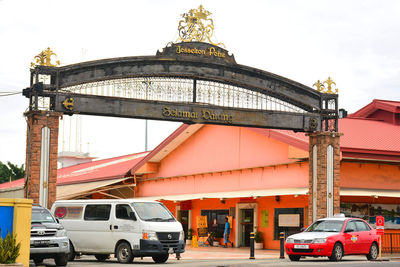 Cars on road against sky in city