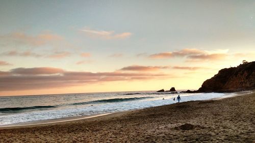 Scenic view of beach against sky during sunset