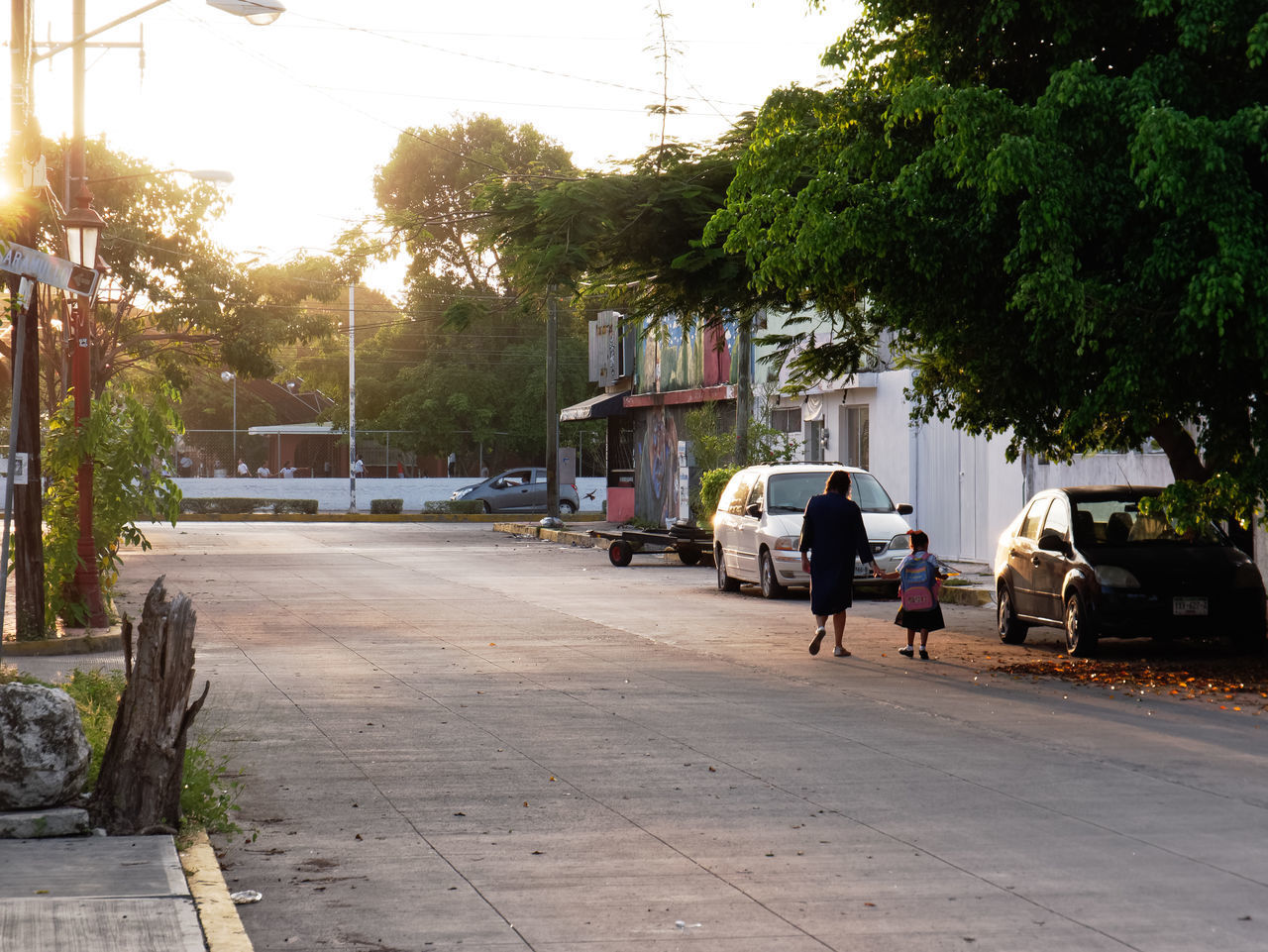 REAR VIEW OF PEOPLE WALKING ON STREET