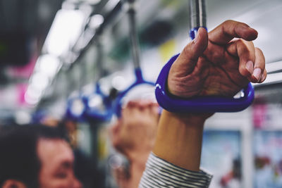 Close-up of hand hanging in city