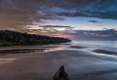 Scenic view of sea against sky at sunset