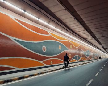 Man riding bicycle on road in city