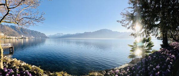 Scenic view of lake by mountains against sky