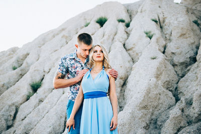 Young couple standing on rock