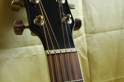 Cropped image of guitar on fabric