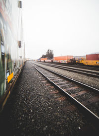 Train on railroad tracks against clear sky