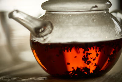 Tea leaves in pot on table