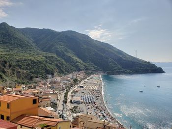 High angle view of city by sea against sky