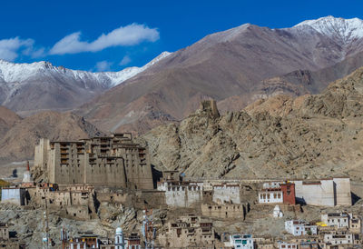 Buildings in town against mountains