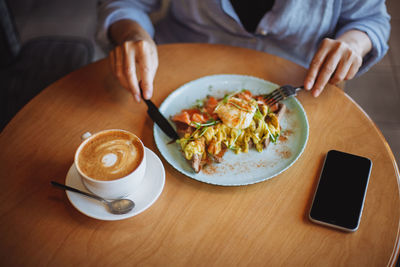 Midsection of man having breakfast