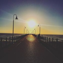 Pier on sea at sunset