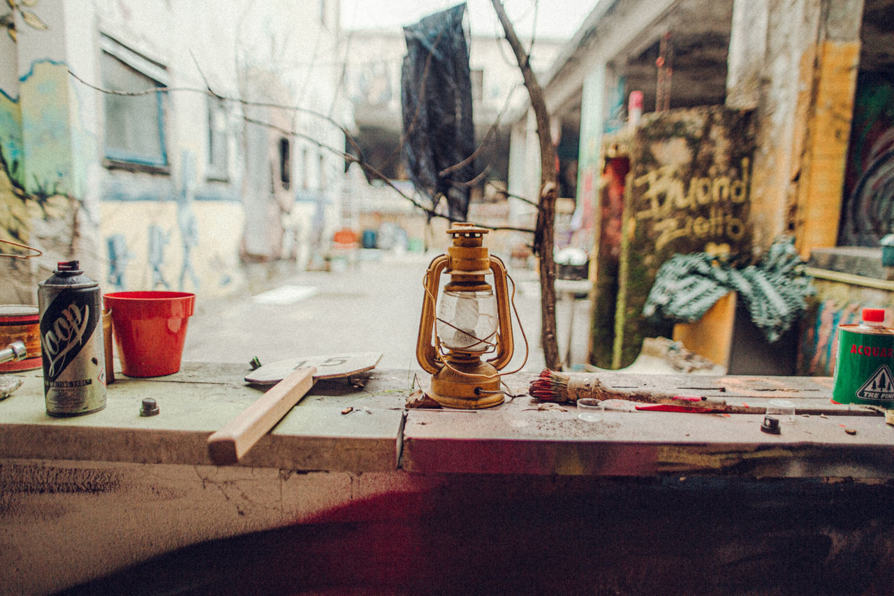 indoors, table, glass - material, no people, container, architecture, education, instrument of measurement, still life, built structure, transparent, laboratory, science, day, window, equipment, wood - material, workshop, old, electric lamp