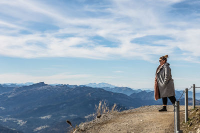 Woman walking on land against sky