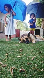 Full length of girl and dog on grass