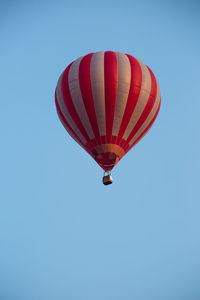 Low angle view of hot air balloon against clear blue sky