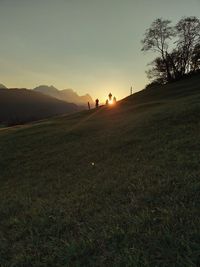 Scenic view of field against sky during sunset