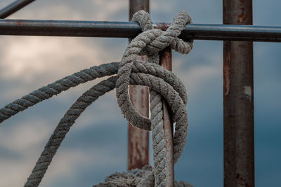 Close-up of rope tied on railing