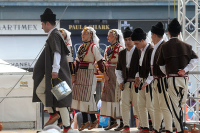 Smiling traditional dancers performing on stage