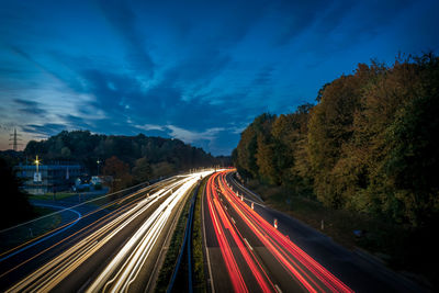 Road passing through illuminated tunnel