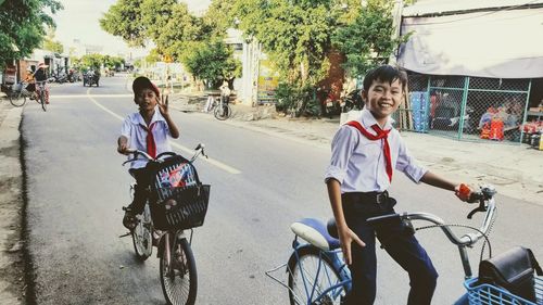 People riding bicycle on street in city