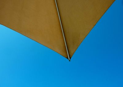 Low angle view of beach umbrella against clear sky