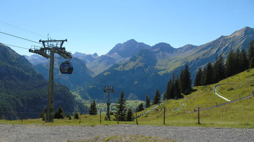 Scenic view of mountains against blue sky